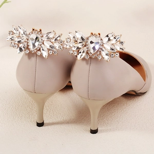 Macro shot of high heel pump rear featuring large luxury crystal wing embellishments