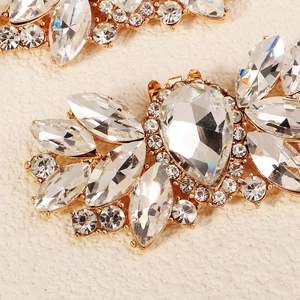 Macro detail of luxury gold alloy shoe clip with marquise-cut crystal rhinestones