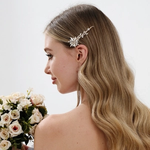 Detail view of a floral rhinestone bridal hair clip worn by a model for elegant wedding styling