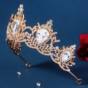 Detail of baroque gold bridal crown featuring pear-shaped crystals and leafy hollow design