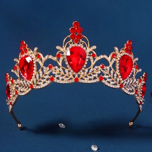 Detail of vintage Baroque bridal crown with red pear-cut gems and gold filigree