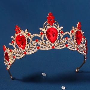 Baroque gold bridal crown featuring large red teardrop gemstones and crystal embellishments