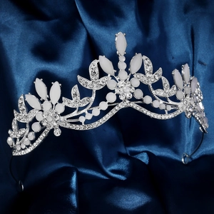 Close-up of silver bridal crown with white leaf gems and sparkling rhinestones