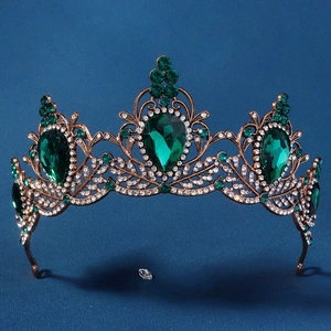 Detail of vintage bronze tiara with large emerald green teardrop crystals and rhinestones