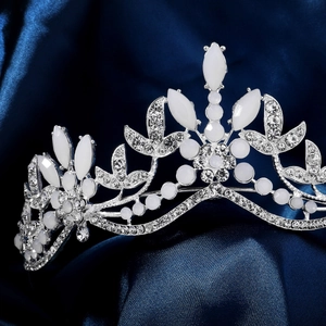 Close-up of bridal crown featuring marquise opals and crystals on blue silk