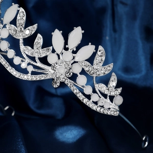 Close-up of silver bridal crown with white rhinestones and marquise opal floral details