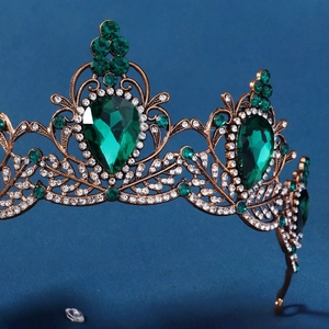 Detailed close-up of Baroque emerald tiara with vintage bronze alloy and crystals