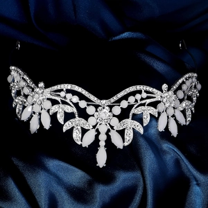 Detailed close-up of bridal tiara featuring white marquise stones and silver floral patterns