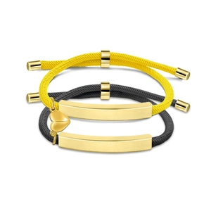 Handwoven stainless steel couple bracelets with gold heart magnetic charms in yellow and black