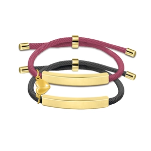 Detailed view of handmade woven couple bracelets with heart charms and gold metal bars