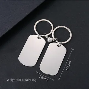 Detailed view of polished stainless steel couple keychains with magnetic heart, size 50x28mm