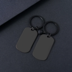 Detail of magnetic heart connection between two black matte stainless steel couple keychains