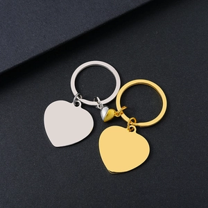 Close-up of magnetic heart-shaped stainless steel couple keychains with a polished finish