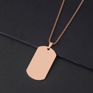 Polished rose gold stainless steel dog tag pendant with a box chain on a dark background