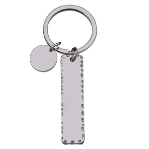 Detailed close-up of a silver metal keychain with a textured hammered edge rectangle pendant