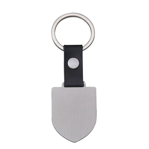 Customizable metal and black leather keychain with a shield-shaped dog tag on white background