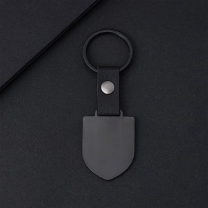 Minimalist matte black shield metal keychain with litchi grain leather strap and round ring