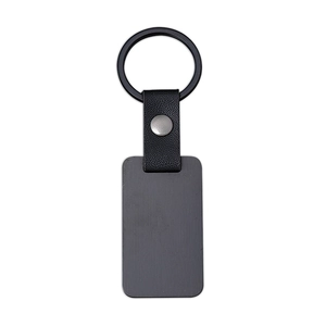 Minimalist black leather keychain with a matte black metal tag on white background