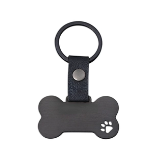 Black bone shaped metal pet ID tag with hollow paw print and leather keychain strap