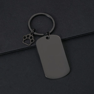 Close-up of black matte stainless steel keychain with dog paw charm and blank tag