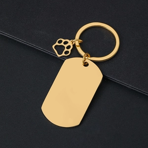 Polished gold metal military dog tag keychain with a hollow footprint charm and mirror finish