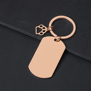 Polished rose gold rectangular military tag keychain with a tiny hollow footprint charm