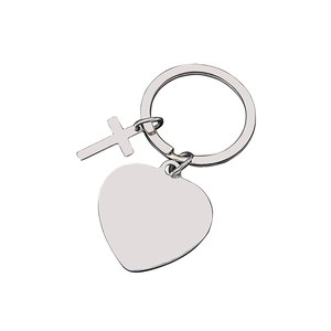 Polished silver metal keychain with heart pendant and cross charm on a key ring