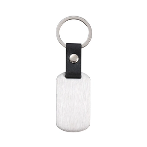Detail of a rectangular metal keychain with black leather strap and silver ring connector