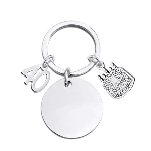Silver metal keychain with 40th birthday cake pendant and round engraving plate detail