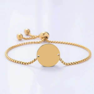 Dettaglio del bracciale a catena box dorato con chiusura a scorrimento e ciondolo rotondo