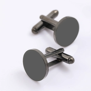Detailed macro view of 15mm gunmetal round cufflinks with bullet back closure
