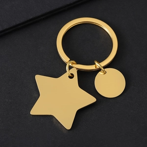 Golden stainless steel pentagram star and round disc keychain on a black background
