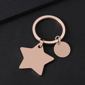 Rose gold stainless steel star and round disc keychain for custom engraving on black background