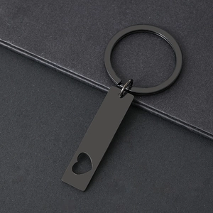 Detail of matte black stainless steel keychain with minimalist heart hollow out design