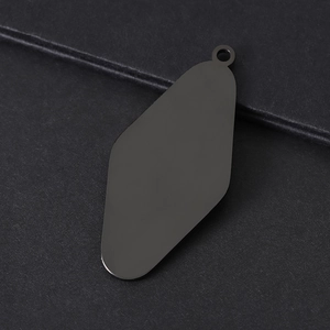 Macro detail of matte black stainless steel diamond-shaped blank keychain tag for DIY