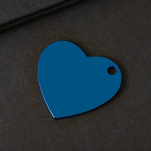 Detail of dark blue heart-shaped stainless steel keychain blank with a smooth metal surface