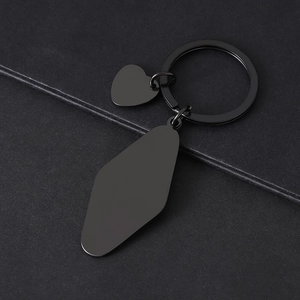 Macro shot of matte black stainless steel keychain with diamond and heart pendants