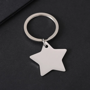 Polished silver star-shaped keychain on grey background with premium metallic texture