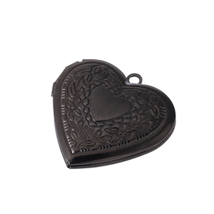 Vintage heart locket necklace with floral engraving in bronze finish on white background