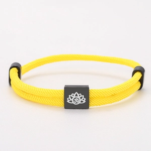 Adjustable yellow Milan rope bracelet with black square lotus and Om symbol charm