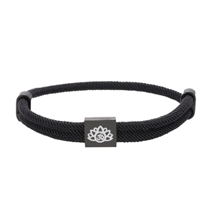 Adjustable black woven Milan rope bracelet with engraved lotus and Om symbol charm