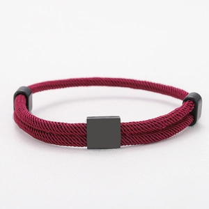 Detail view of burgundy braided Milan rope bracelet with matte black square metal plate