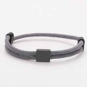 Detail of grey braided Milanese cord bracelet with minimalist black square metal clasp
