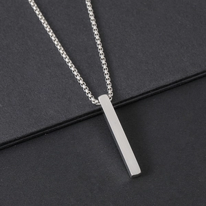 Detailed view of a minimalist solid rectangular pillar pendant with brushed metal finish