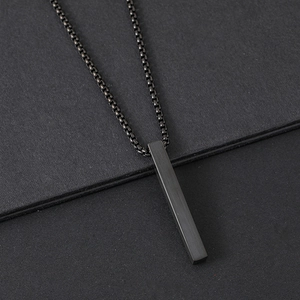 Macro shot of minimalist black brushed stainless steel bar pendant with bead chain