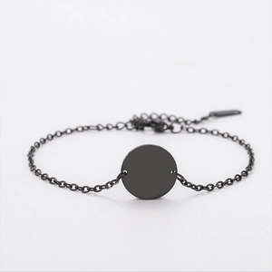 Macro detail of minimalist black stainless steel bracelet with round tag and adjustable chain