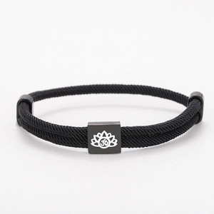 Adjustable black braided rope bracelet featuring a black Lotus and Om symbol charm