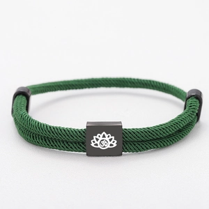 Adjustable green woven rope bracelet with black lotus charm and Om symbol engraving
