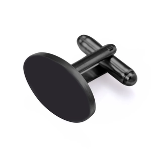 Macro shot of black oval cufflink featuring a matte finish and T-bar swivel closure