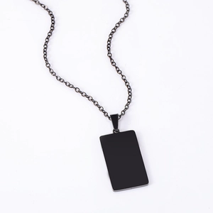 Close-up of minimalist black matte stainless steel rectangular pendant with metallic O-chain